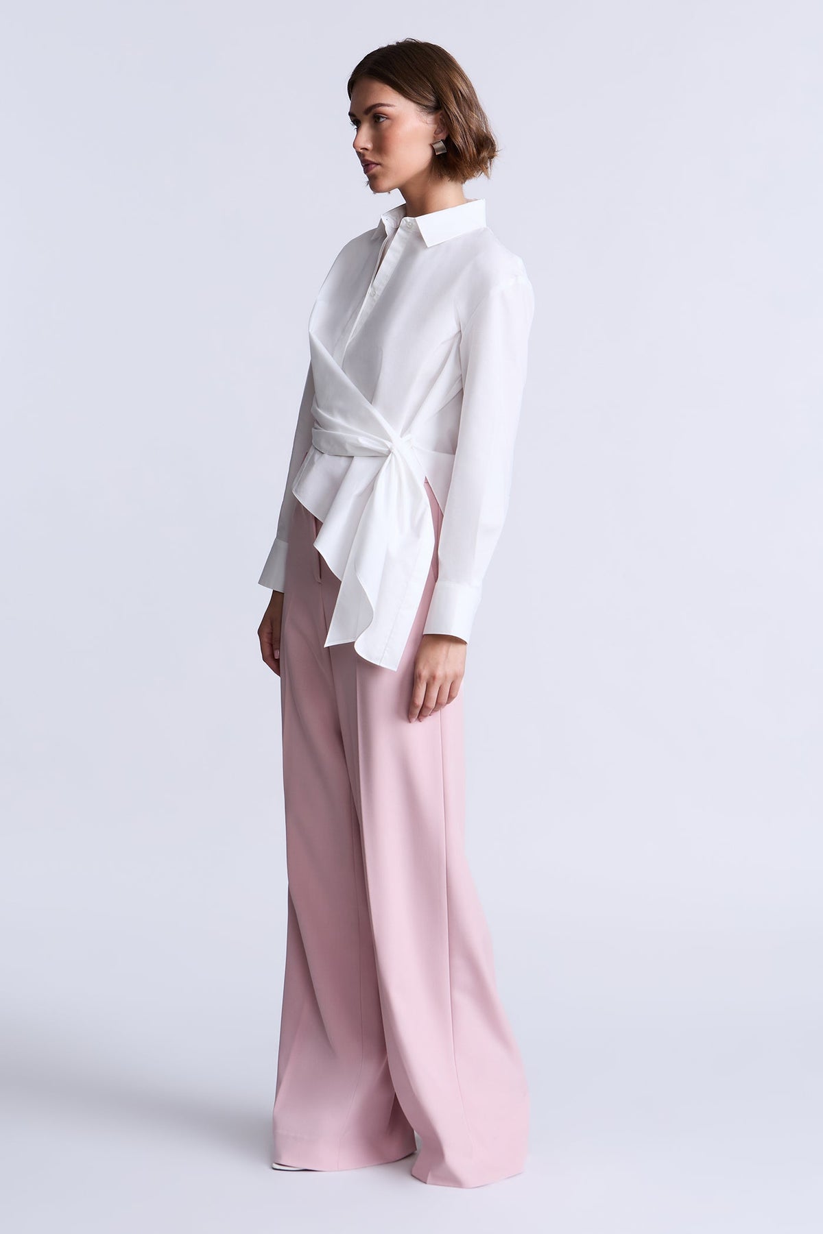 BCBGMAXAZARIA Crisp cotton wrap Tay shirt with a soft breathable feel and an unexpected asymmetric finish